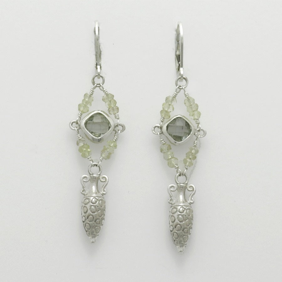 Pair of silver amphora drop earrings with green gemstones on a light gray background, handmade by Izaskun Zabala.