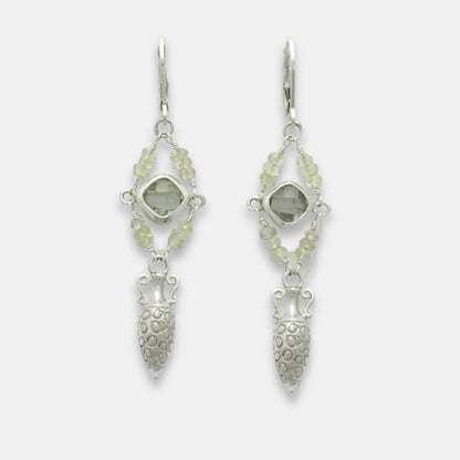 Pair of silver drop amphora earrings with green amethyst and moonstone beads on a white background, handmade by Izaskun Zabala.
