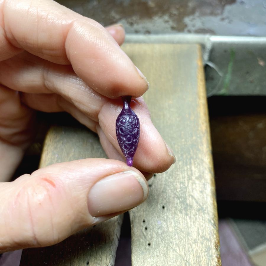 Image is a wax carved amphora charm prototype, handmade by Izaskun Zabala.