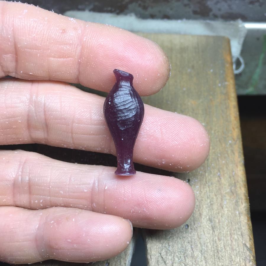 Image is wax carving an amphora pendant prototype, handmade by Izaskun Zabala.