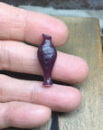 Image is wax carving an amphora pendant prototype, handmade by Izaskun Zabala.