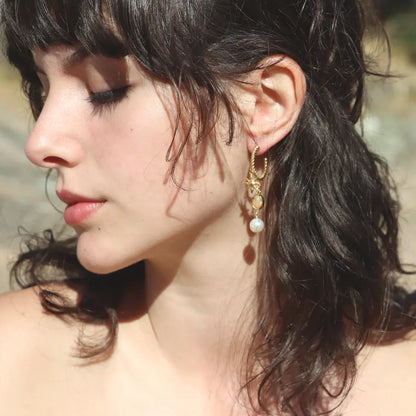 Gold-plated Alba drop Hoops with sun charm, fire opal and pearl, worn on a model