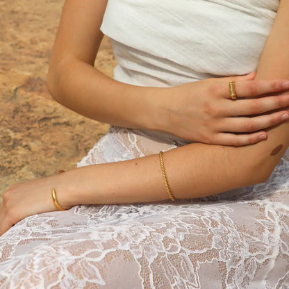 Rope like Ariadne Cuff in gold-plated brass styled on a model