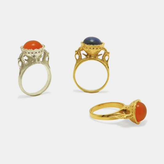 Three chalice alike gold-plated and silver rings with different gemstone cabochons.