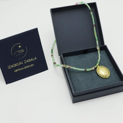 Beaded Gaia Necklace with a gold-plated pendant in an Izaskun Zabala branded box.
