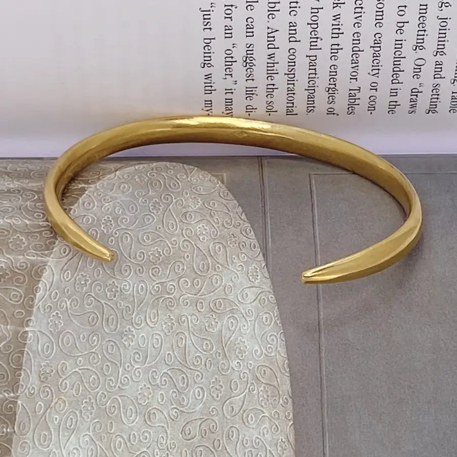 Handcrafted gold-plated open bracelet shown from the side