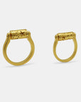 Side view of gold-plated rings with a rotating top cilinder, handmade by Izaskun Zabala.
