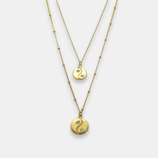 Two gold-plated yin yang pendants with sapphires necklaces, handmade by Izaskun Zabala.