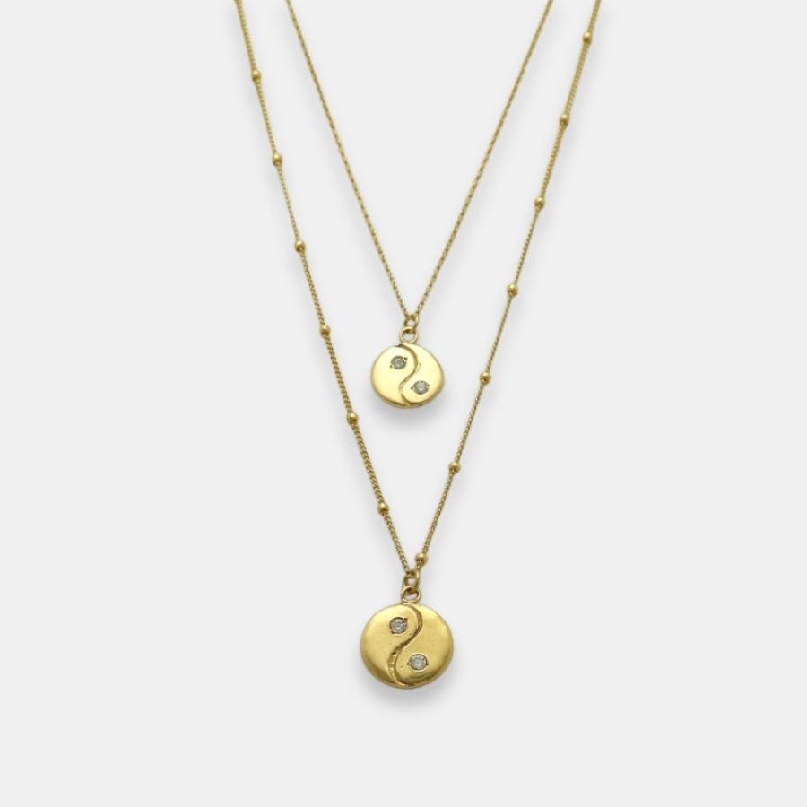 Two gold-plated yin yang pendants with sapphires necklaces, handmade by Izaskun Zabala.