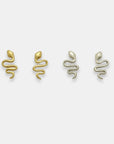 Two pairs of snake-shaped earrings, one gold-plated and one silver, handcrafted by Izaskun Zabala.