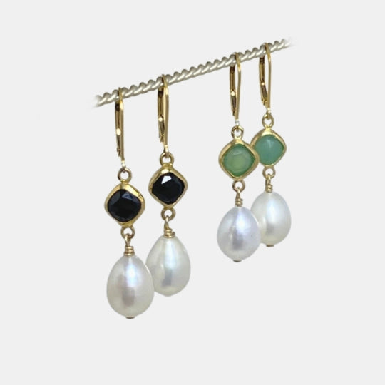 Image is a set of 24K gold plated earrings with a baroque pearl dangling from a cushion cut stone, handmade by Izaskun Zabala.