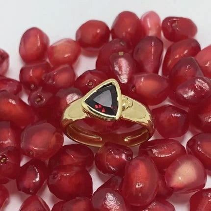 18K gold ring with a red garnet on a bed of red pomegranate seeds, artisan made by Izaskun Zabala.
