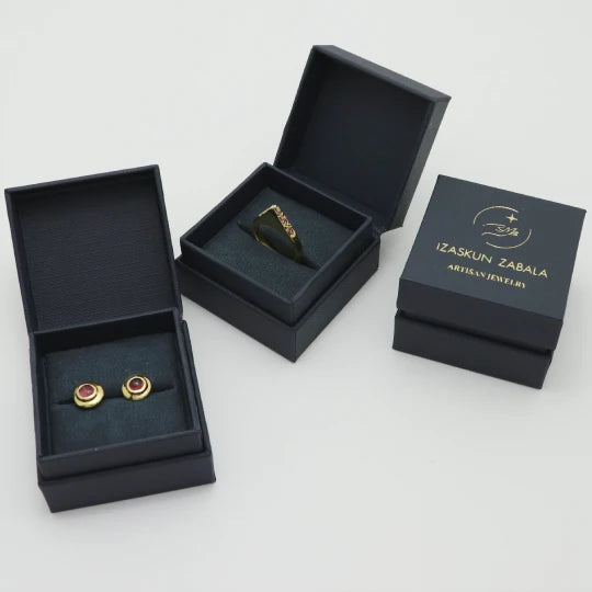 Handmade gold-plated ring and studs in Izaskun Zabala branded packaging.