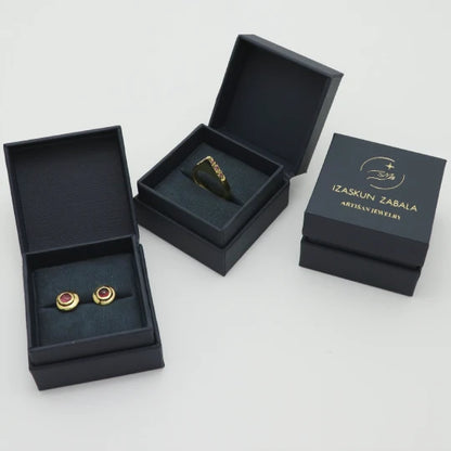 Handmade gold-plated ring and studs in Izaskun Zabala branded packaging.