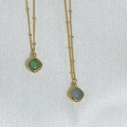 Image is a set of gold filled chain necklaces with a cushion cut gemstone pendant, handmade by Izaskun Zabala.