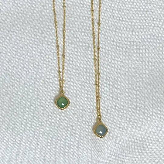 Image is a set of gold filled chain necklaces with a cushion cut gemstone pendant, handmade by Izaskun Zabala.