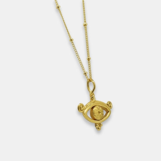 Side view of symbolic necklace with all-seeing eye inspired pendant, handmade by Izaskun Zabala.