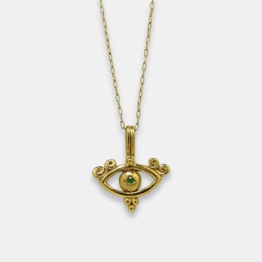 Gold-plated symbolic necklace with all-seeing eye inspired pendant and green tsavorite, handmade by Izaskun Zabala.