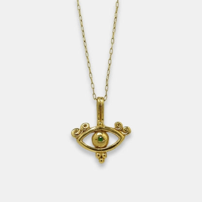 Gold-plated symbolic necklace with all-seeing eye inspired pendant and green tsavorite, handmade by Izaskun Zabala.