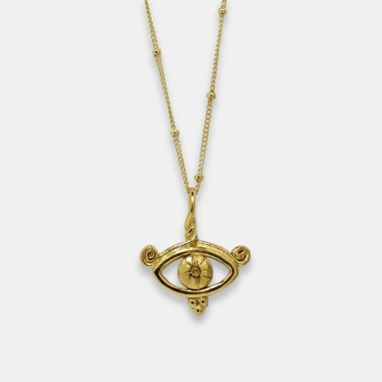 Gold-plated symbolic necklace with all-seeing eye inspired pendant, handmade by Izaskun Zabala.