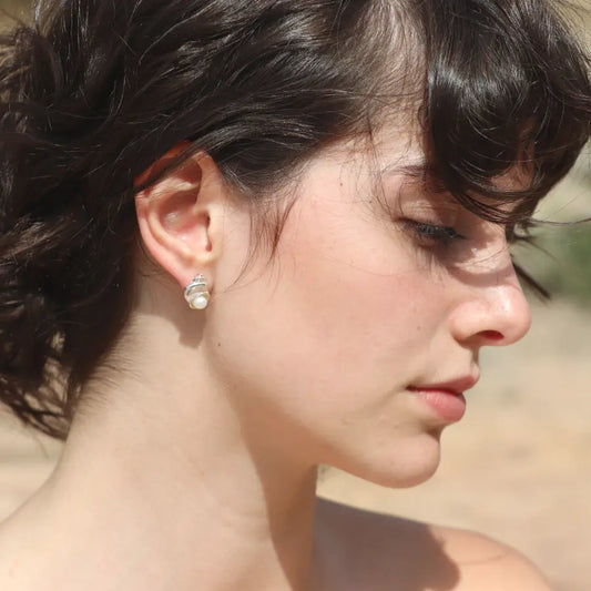 Sterling silver Nerea Earrings featuring round button pearls worn on a model