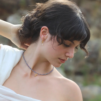Nixie seahorse gold-plated necklace with dark pearls and pink tourmalines worn on a model with snake earrings