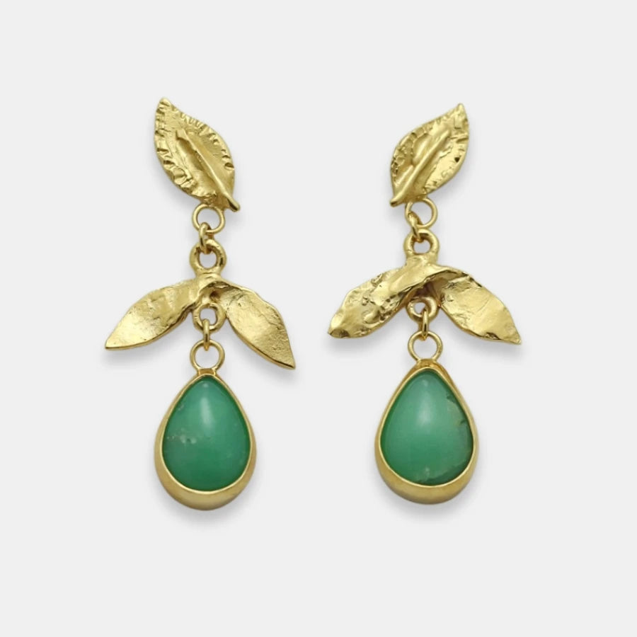 Gold-plated leaf earrings with green teardrop stone, handmade by Izaskun Zabala.