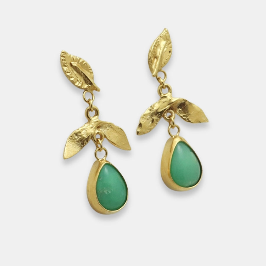 Side view of gold-plated leaf earrings with green teardrop stone on a white background.