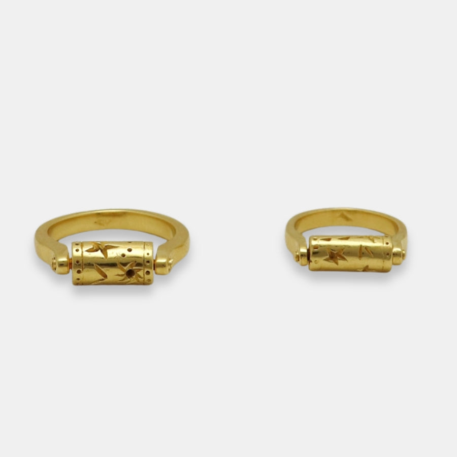 Flat view of gold-plated rings with a rotating top cilinder, handmade by Izaskun Zabala.