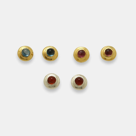 Round studs with natural cabochon gemstones in 24k gold-plated brass and silver by Izaskun Zabala.