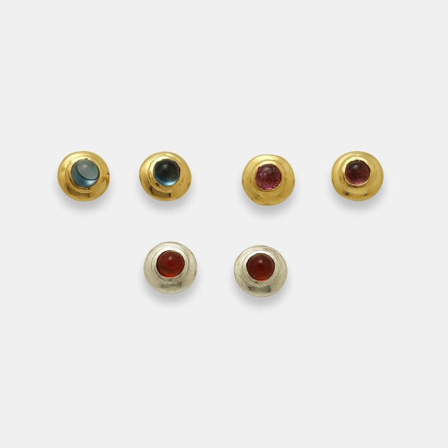 Round studs with natural cabochon gemstones in 24k gold-plated brass and silver by Izaskun Zabala.