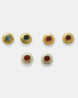 Round studs with natural cabochon gemstones in 24k gold-plated brass and silver by Izaskun Zabala.