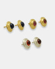 Side view cabochon gemstone round stud earrings in silver and gold-plated brass, artisan made by Izaskun Zabala.