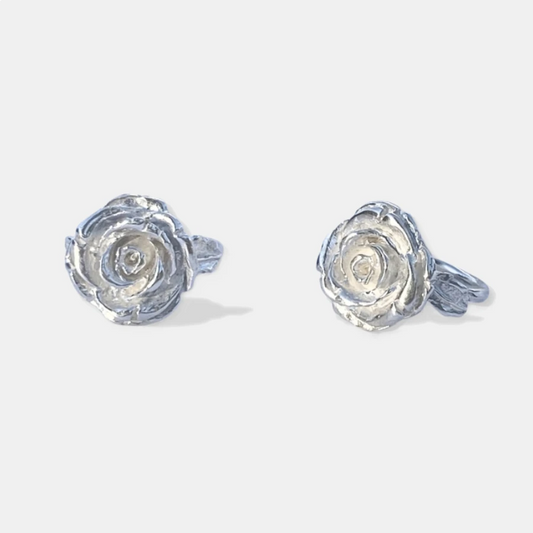 A pair of handmade silver rose-shaped carved rings.