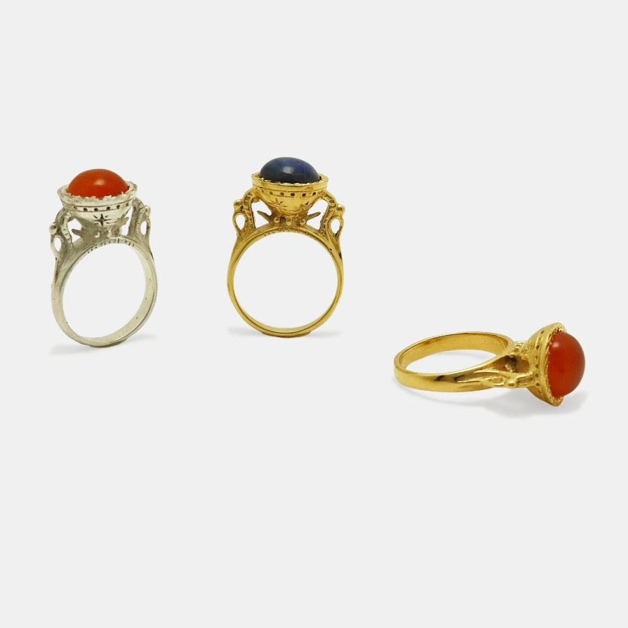 Three chalice alike gold-plated and silver rings with different gemstone cabochons, made by artisan Izaskun Zabala.