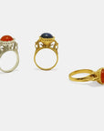 Three chalice alike gold-plated and silver rings with different gemstone cabochons, made by artisan Izaskun Zabala.