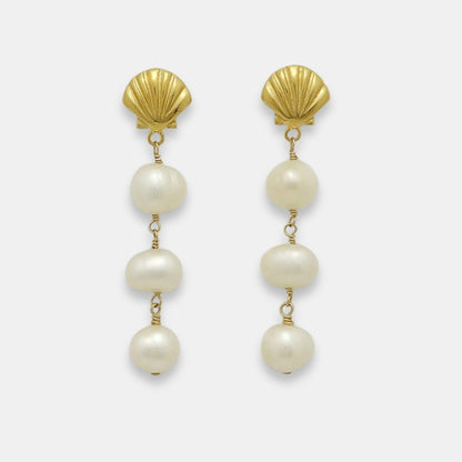 Pair of gold-plated earrings with shell studs and pearl drops, handmade by Izaskun Zabala.