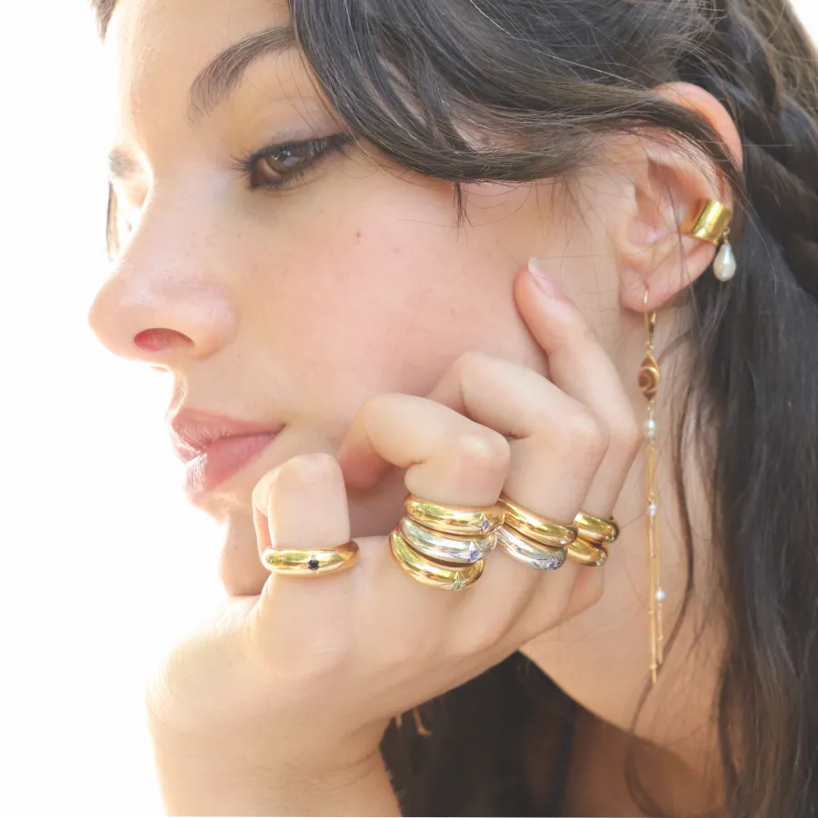 Gold-plated and silver Venus Star Rings with center gemstone styled on a model