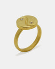 Side view of a gold-plated yin yang ring with two sapphires, artisan made by Izaskun Zabala.
