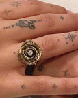 Image is a hand carved statement rose ring in brass with a three millimetre white cubic zirconia as center stone